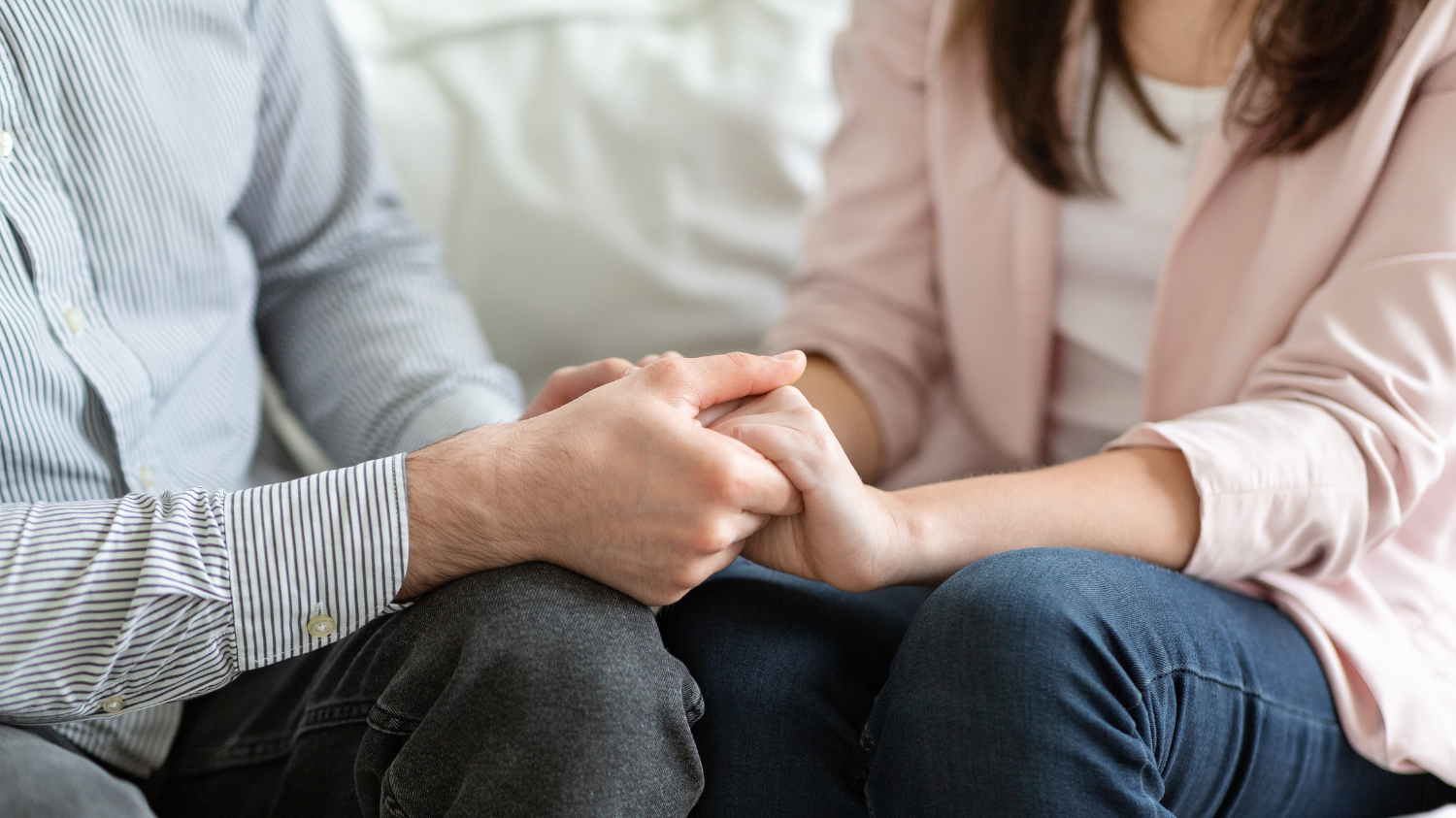 Two hands reaching for each other, symbolizing connection and hope.